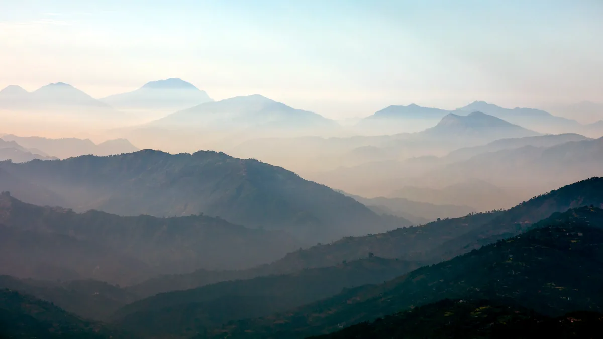 Distant mountains fading into a cold blue haze.