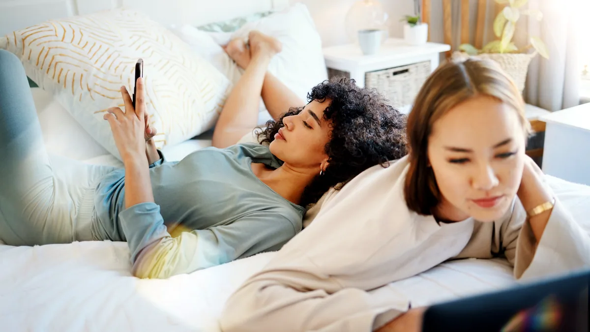 A phone streaming a movie in a dim bedroom.
